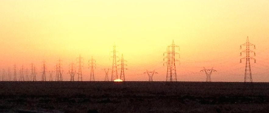 The sun sets behind pylons in the Jebel Nafusa, but Libyans are not paying for what they use  (Photo: Tom Westcott)