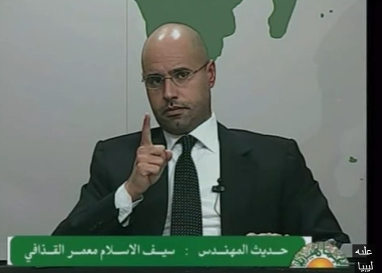 Saif al-Islam Qaddafi buried in Bani Walid next to his brother – thousands attend funeral as supporters of former regime display old green flag