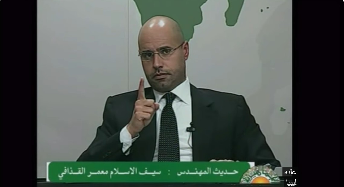 Saif al-Islam Qaddafi buried in Bani Walid next to his brother – thousands attend funeral as supporters of former regime display old green flag